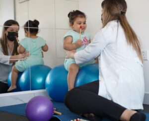 Doctor-holding-baby-best-physiotherapy-clinic-helena-taylor-clinic