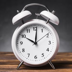 white-alarm-clock-wooden-textured-table-showing-10-oclock Bumps, babies & beyond fair - Dr. Helena Taylor Clinic